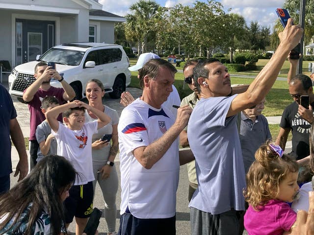 Former Brazil president Jair Bolsonaro, centre, meets with supporters outside a holiday home where he is staying near Orlando, Florida, on January 4