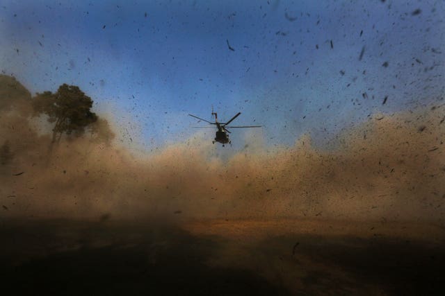 A helicopter carrying bodies of victims arrives in Kathmandu, Nepal