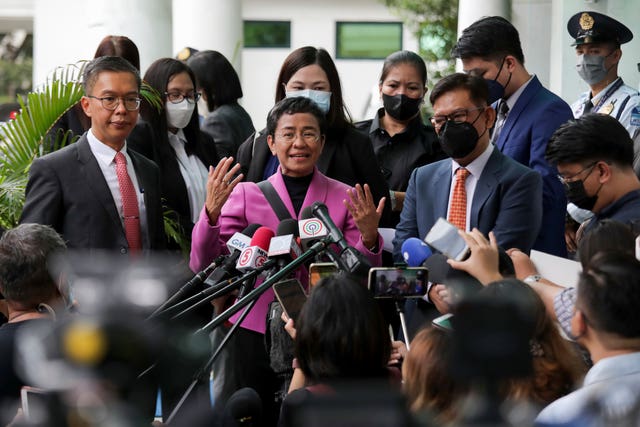 Filipino journalist Maria Ressa, center, one of the winners of the 2021 Nobel Peace Prize and Rappler CEO, speaks to the media after a court decision at the Court of Tax Appeals in Quezon City, Philippines Wednesday, Jan. 18, 2023. 