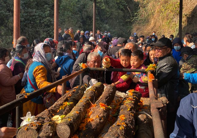 Relatives and friends perform last rites in Pokhara, Nepal
