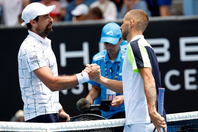 Jeremy Chardy, left, and Dan Evans shake hands at the end of the match 