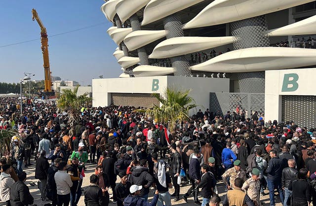 Iraqi football fans try to enter the Basra International Stadium