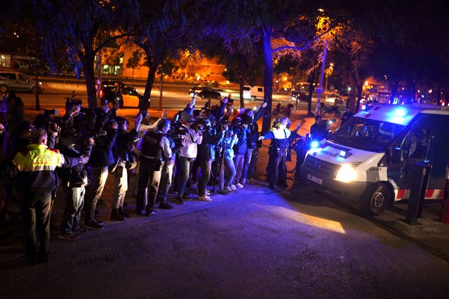 Reporters take pictures of a police van, reportedly carrying Dani Alves, outside the Barcelona courthouse
