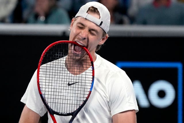 Denis Shapovalov bites his racket in frustration during his loss to Hubert Hurkacz