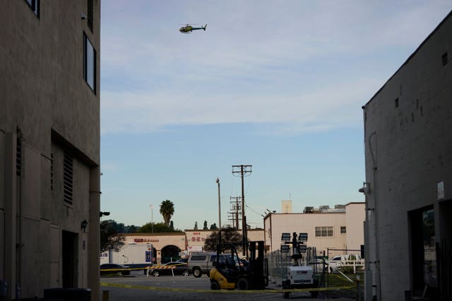 A law enforcement helicopter hovers over Star Dance Studio in Monterey