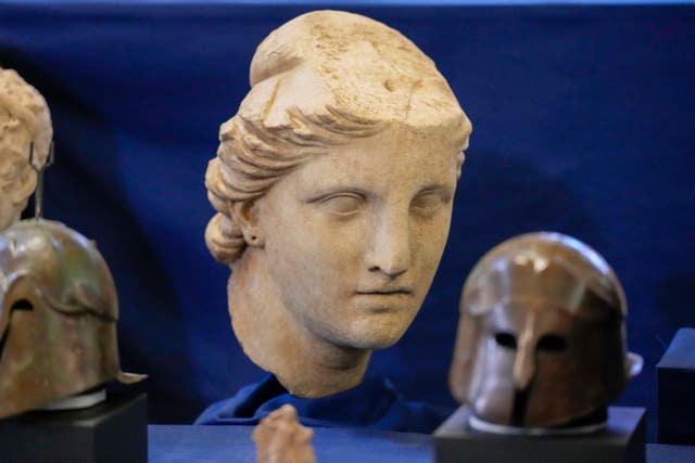 A marble head of Atena, dated to the II century BC, is seen on display among other archaeological artefacts stolen from Italy and sold in the US by international art traffickers, during a press conference in Rome 