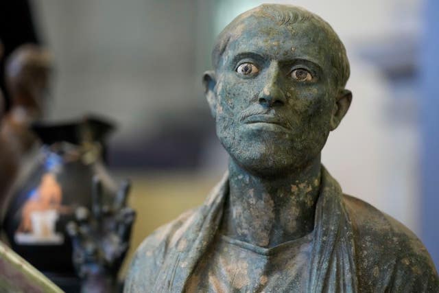 A bronze male bust, dated between the first century BC and the first century AC, is seen on display among other archaeological artefacts stolen from Italy and sold in the US by international art traffickers, during a press conference in Rome