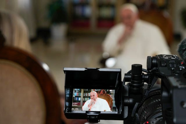 Pope Francis ponders a question during the interview