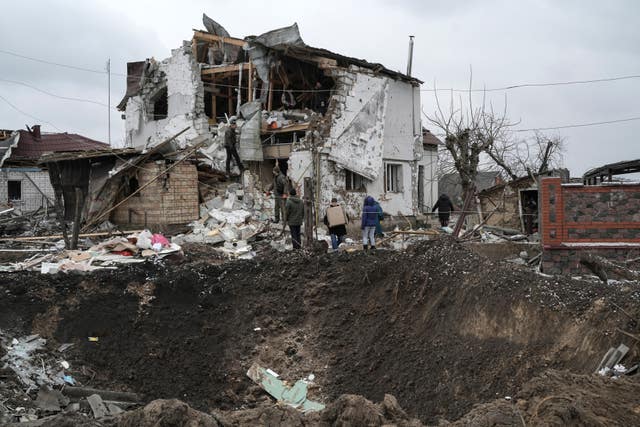 A crater is seen next to a destroyed house after a Russian rocket attack in Hlevakha, Kyiv region, Ukraine