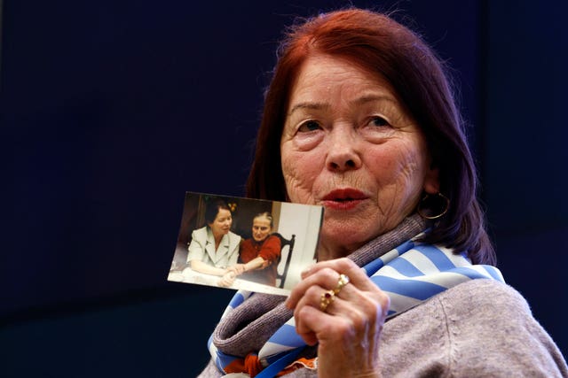 Holocaust survivor Stefania Wernik shows her family picture as she attends a meeting of survivors with media in Oswiecim, Poland