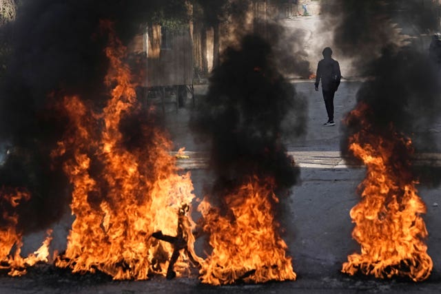 Palestinian demonstrators burn tyres in a protest against a deadly Israeli army raid at Aida Refugee camp, in the West Bank city of Bethlehem 