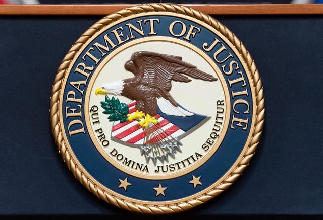 The Department of Justice seal is seen before a news conference to announce an international ransomware enforcement action at the Department of Justice in Washington 