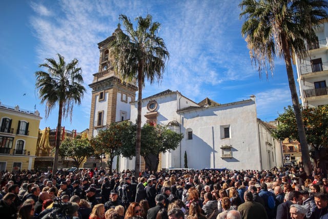 Residents gather after a minute of silence for a church sacristan who was killed in Algeciras, southern Spain
