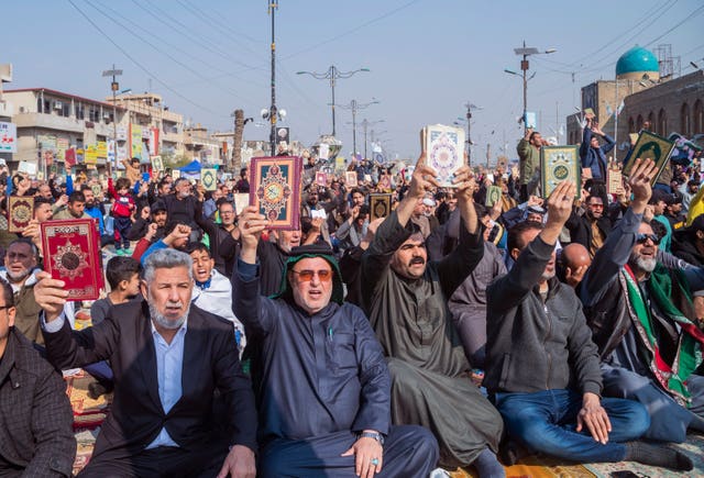 Followers of the Shiite cleric Muqtada al-Sadr raise the Koran, the Muslim holy book, in response to the burning of a copy of the Koran in Sweden, during open-air Friday prayers in Baghdad, Iraq