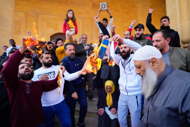 Scores of angry protesters in Beirut, Lebanon, burn Swedish and Netherlands flags after Friday prayers outside Mohammad al-Amin Mosque to denounce the recent desecration of Islam’s holy book by far-right activists in the European countries 