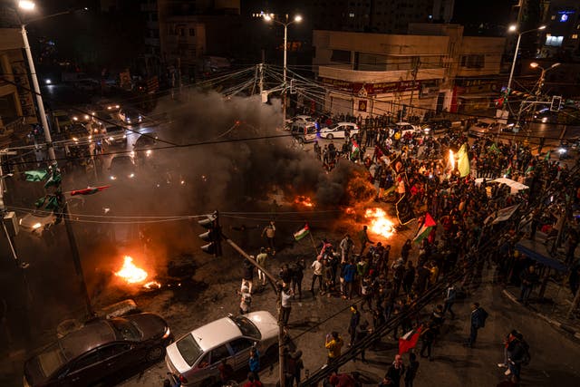 Palestinians in Gaza City celebrate after a shooting attack near a synagogue in Jerusalem