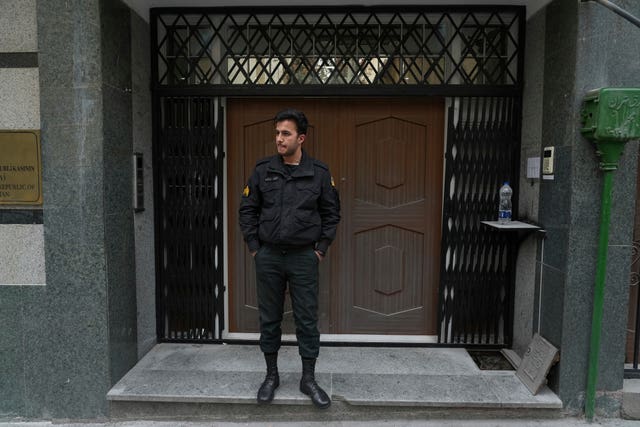 A police officer stands in front of the Azerbaijan embassy in Tehran, Iran