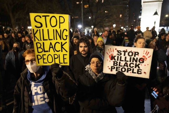 Demonstrators raise signs during a protest at Washington Square Park in New York, in response to the death of Tyre Nichols 