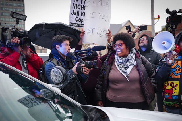 Activists momentarily surround an MPD cruiser during a march for Tyre Nichols