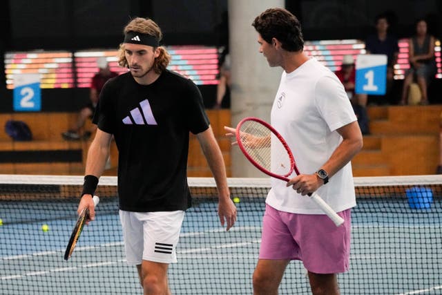 Stefanos Tsitsipas, left, speaks to coach Mak Philippoussis in practice ahead of the final 