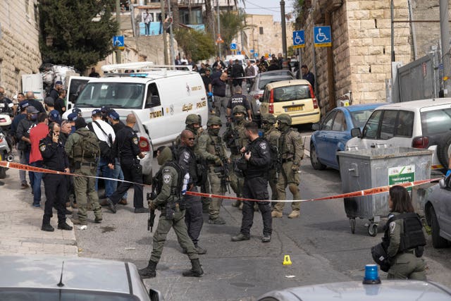 An Israeli policeman secures a shooting attack site in east Jerusalem 