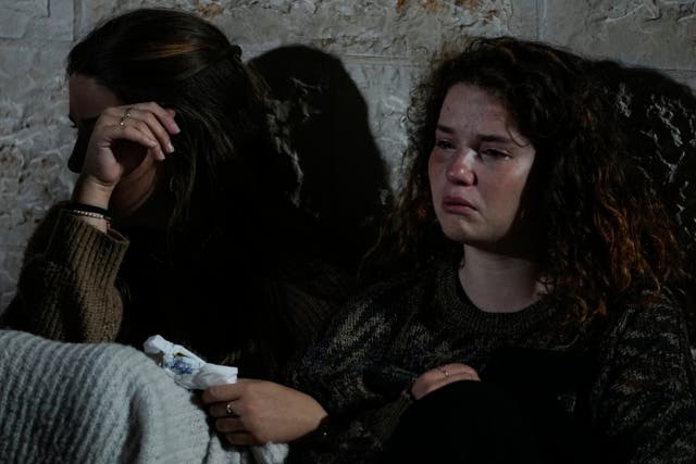 Mourners react during the funeral of Israeli Eli Mizrahi and his wife, Natalie, victims of Friday's attack