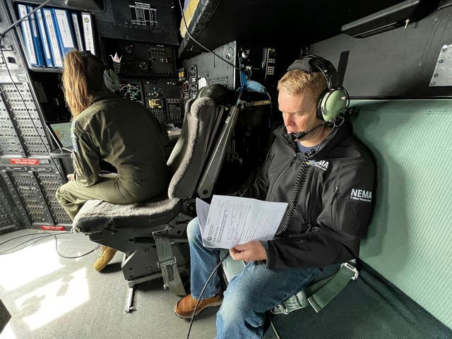 New Zealand Prime Minister Chris Hipkins sits in a military plane bound for Auckland to assess the rain and flooding damage