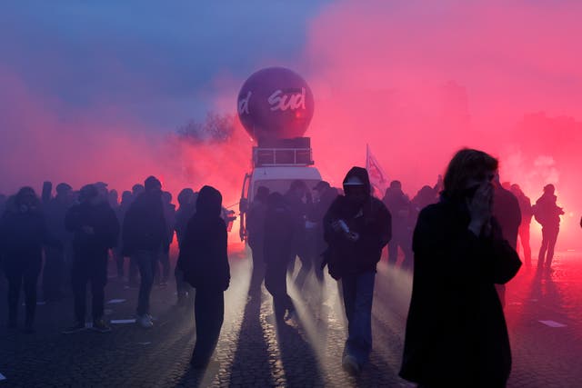 Demonstrators arrive near the Invalides monument during a demonstration against plans to push back France’s retirement age in Paris