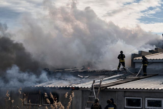 Firefighters tackle a blaze after Russian shelling hit an industrial area in Kherson, Ukraine