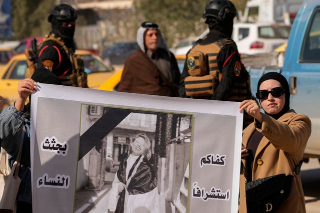 Demonstrators carry a poster with a picture of Tiba Ali, a YouTube star who was recently killed by her father, in Diwaniya, Iraq