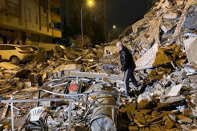 A man searches rubble