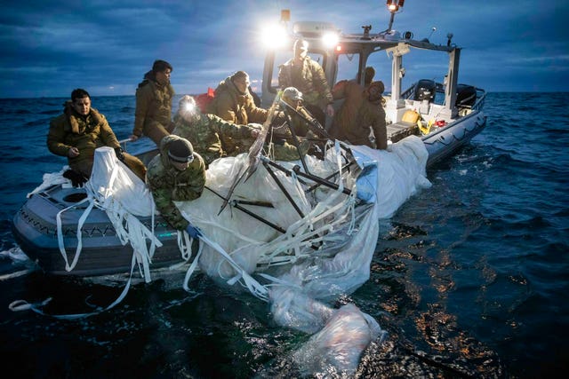 Sailors recovering a high-altitude surveillance balloon off the coast of Myrtle Beach