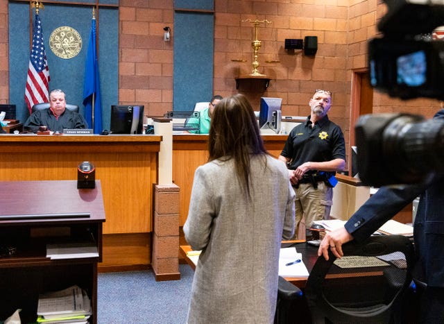 Public defender Kristy Holston, centre, addresses the court