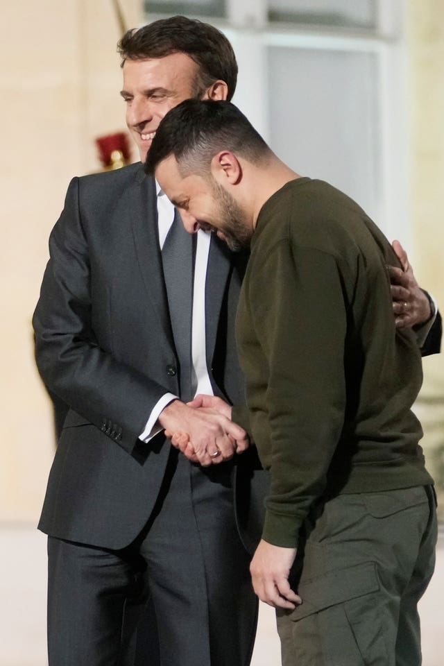 Volodymyr Zelensky and Emmanuel Macron shake hands