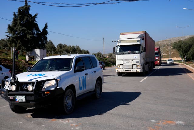 Trucks with aid for Syria follow a UN vehicle 