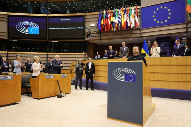 European Parliament’s members applaud Ukraine’s President Volodymyr Zelensky, centre right front