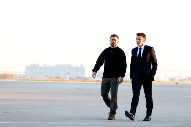 French President Emmanuel Macron, right, walks next to Ukraine’s President Volodymyr Zelensky before heading to Brussels