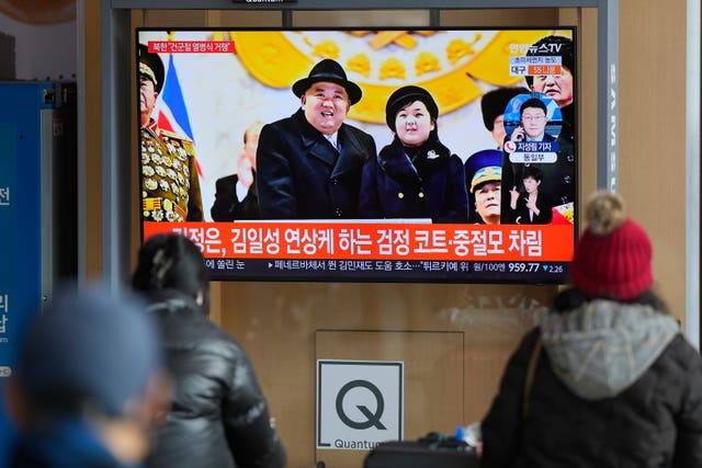 A TV screen shows an image of North Korean leader Kim Jong Un with his daughter during a news programme at the Seoul Railway Station in South Korea