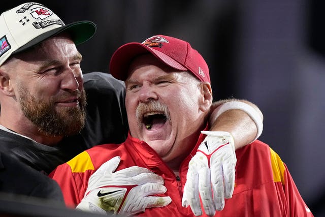 Kansas City Chiefs tight end Travis Kelce, left, embraces head coach Andy Reid