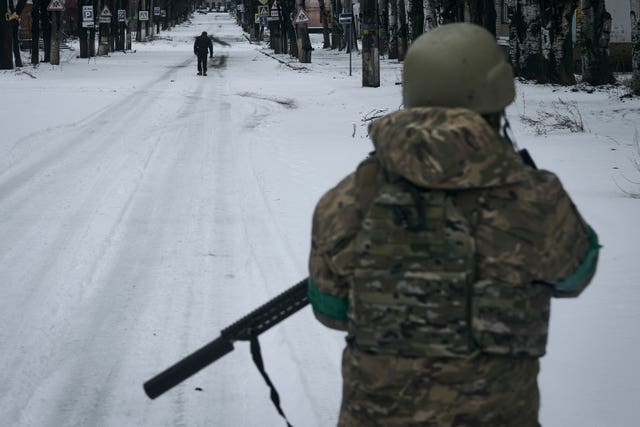 A Ukrainian soldier patrols the street in Bakhmut, Donetsk region, Ukraine 
