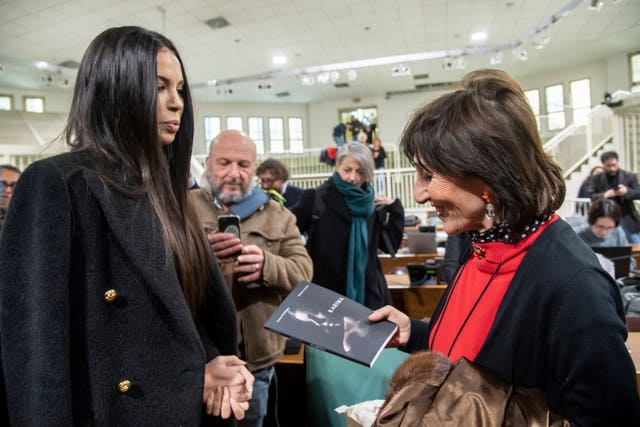 Karima El Mahroug presents her book to prosecutor Tiziana Siciliano, right 