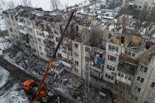 Rescue workers clear the rubble of a residential building destroyed by a Russian rocket in Pokrovsk, Ukraine, on February 15 2023