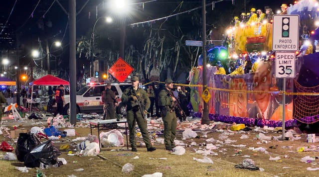 Police work at the scene of a shooting at the Krewe of Bacchus parade