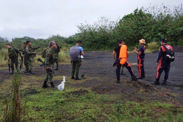 Rescuers prepare to search for passengers of a Cessna 340 aircraft with registry number RP-C2080 at Tumpa Gulley, Camalig town, Albay province, the Philippines