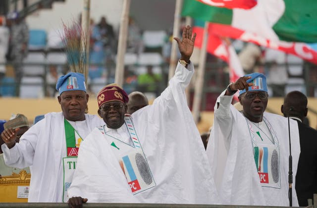 Bola Tinubu, centre, greets supporters during an election campaign rally in Lagos, Nigeria 