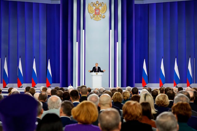 Russian President Vladimir Putin gestures as he gives his annual state of the nation address in Moscow