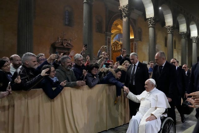 Pope Francis leaves at the end of a mass in the Basilica of Santa Sabina in Rome on Ash Wednesday 