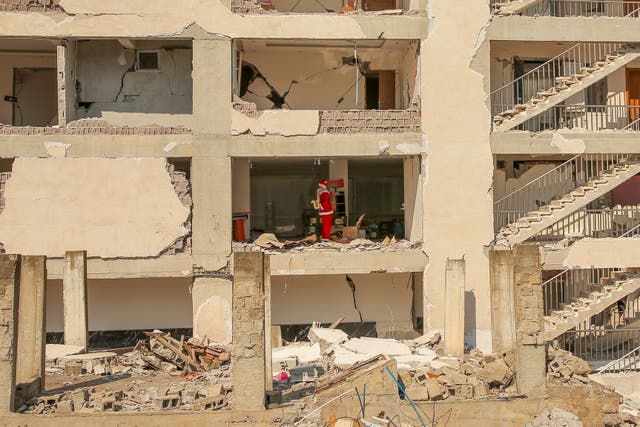 A mannequin dressed as Father Christmas stands inside an apartment of a destroyed building in Turkey following the earthquake 