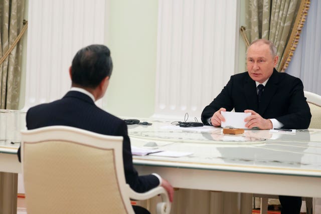 Russian President Vladimir Putin speaks to the Chinese Communist Party’s foreign policy chief Wang Yi at the Kremlin in Moscow