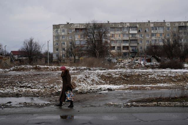 A woman walks in a street in Borodyanka, north of Kyiv, Ukraine 